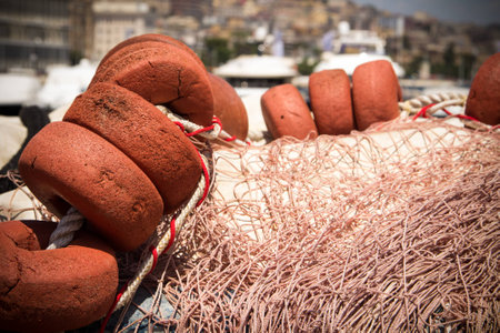 Background with a pile of fishing nets ready to be cast overboard for a new days fishing