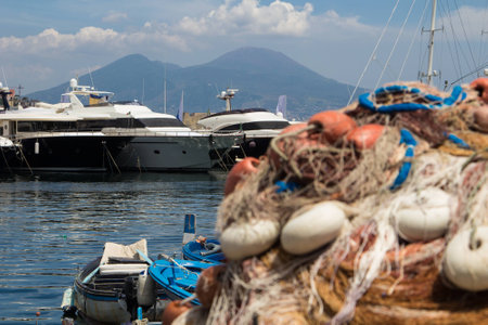 The view on the mount and volcano Vesuvius behind some fishing net floatsの写真素材