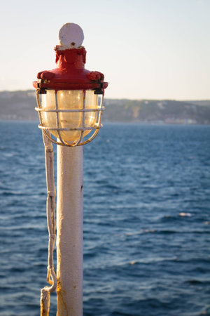 Service Lamp on a ferry on the background of Naples Gulfの写真素材