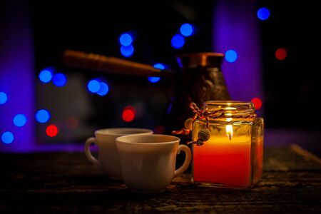 romantic still life with two cups of coffee and a candleの写真素材