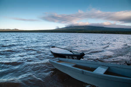 Old boats on the shore of the mountain lake Zyuratkul, Ural, Russia. Cold morning.の写真素材