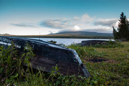 Old boats on the shore of the mountain lake Zyuratkul, Ural, Russia. Cold morning.の写真素材