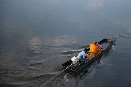 Buddhist monks travel by motorboat With the boat driver in the morning go to receive almsの写真素材
