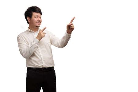 Asian businessman wear white shirt pointing finger by two hands, smiling and feeling happy, isolate on white backgroundの写真素材