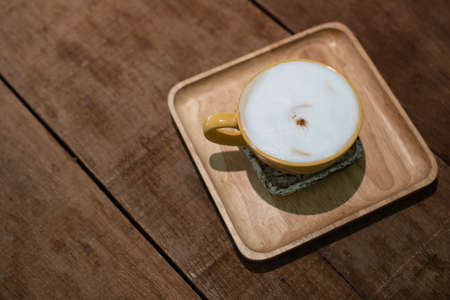 Top view of cup of coffee on wooden tableの写真素材