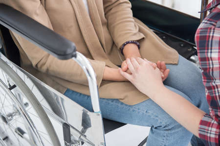 Focus at the pink cancer ribbon on hand of young woman and senior herbreast cancer patient, cancer conceptの写真素材