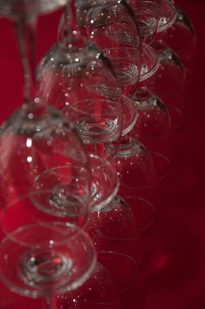 a picture of a set of glasses of wine on red tableの写真素材