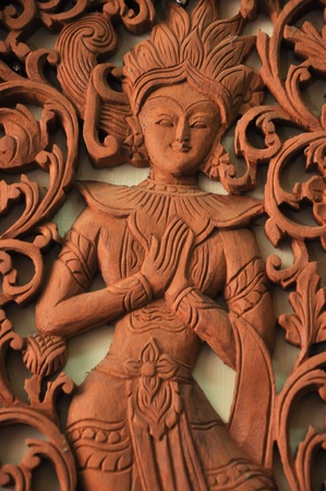 thai art woman deity wood craving in thai templeの写真素材