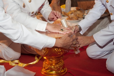 YALA, THAILAND - OCTOBER 14: Mr.Krissada Boonrach Yala Province Governor packs water for keeping Holy water ceremony in keeping Holy water ceremony on Oct 14, 2011 at Yala Cave Temple, Thailandのeditorial素材