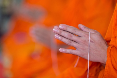 praying monk hand holding holy ropeの写真素材