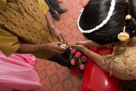consecrated water poured out from the conch shell at thai wedding ceremonyの写真素材