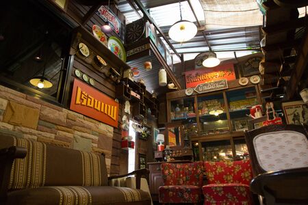 Nakhon Ratchasima, Thailand - July 19: Old vintage furniture, dish, fan and kitchen tools interior decoration in Banmaichaynam restaurant on Jul 19, 2013 at Pak chong Nakhon Ratchasima, Thailandのeditorial素材