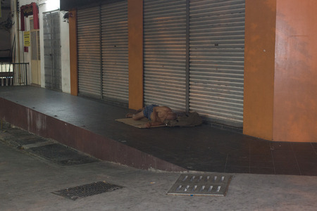 KUALA LUMPUR, MALAYSIA - SEP 27: Unidentified homeless man sleep on foot street in Kuala Lumpur on September 27, 2013 in Kuala Lumpur, Malaysia.のeditorial素材