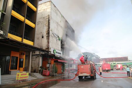 TRANG, THAILAND - AUGUST 12: Fire fighting at Lee Mart, the old shopping center name Diamond plaza...