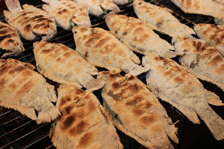 grilled fish cooking on wireの写真素材