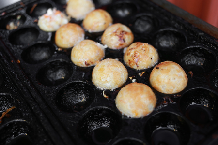 takoyaki, octopus balls, japanese food  on cooking hot panの写真素材