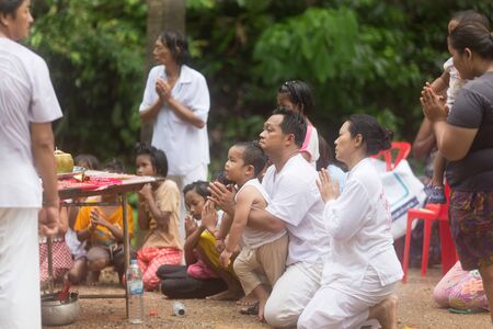Trang, Thailand - October 15, 2018: Son and father pray for chinese god during vegetarian festival in Palian of Trang, Thailand.のeditorial素材