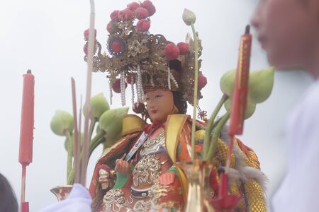 Trang, Thailand - October 15, 2018: Chinese god Tubtim mother statue on chair carry by people during...