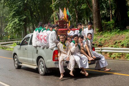 Trang, Thailand - October 15, 2018: Chinese god Monkey King statue on chair carry by people during vegetable festival in Trang, Thailand.のeditorial素材