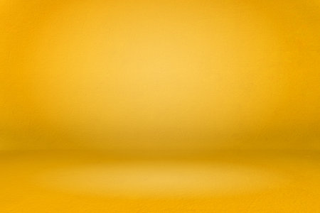Banner of abstract gold gradient spotlight room texture background. Yellow background with little grunge. Studio backdrop wallpaper light room wall golden and empty space.の写真素材