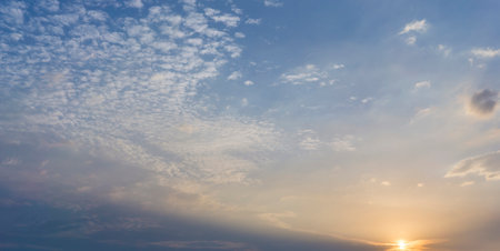 Beautiful view of sky with clouds at sunrise. Partly cloudy. Colorful sunset. Natural blue sky background texture, beautiful color. Sunset landscape in the sky after sunsetの写真素材