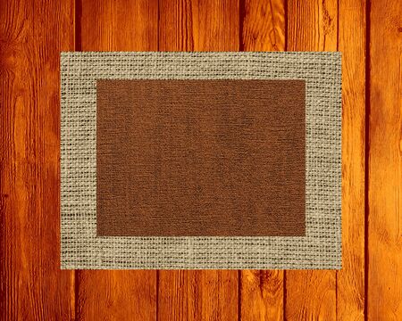 Burlap linen rustic canvas textured on wood backgroundの写真素材