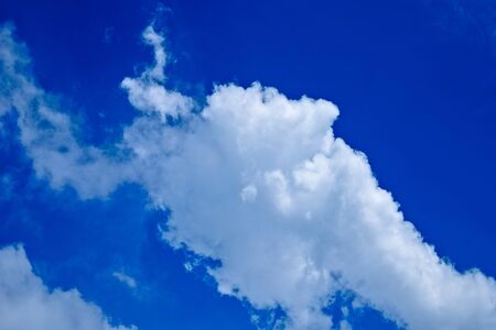 White puffy clouds in blue skyの写真素材