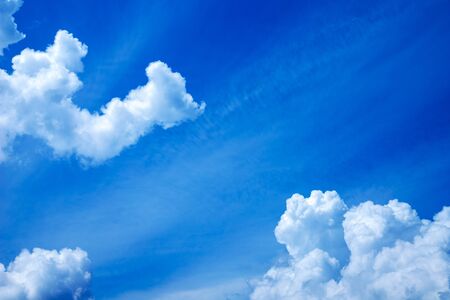 Puffy clouds in blue sky