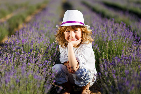 A Boy in a white hat having fun in lavender fieldの写真素材