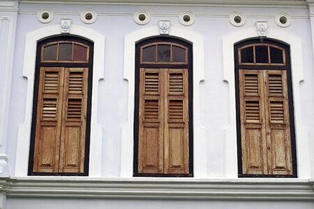 Brown Wood windows in one of old british colonial building.の写真素材