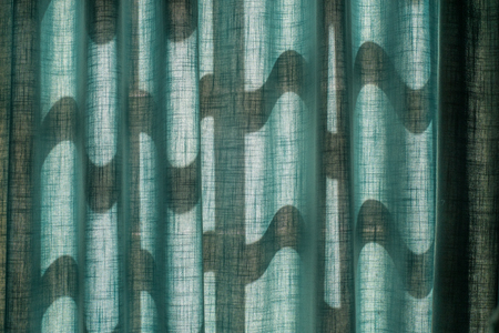 the warm sunshine on the blue curtains, texture, backgroundの写真素材