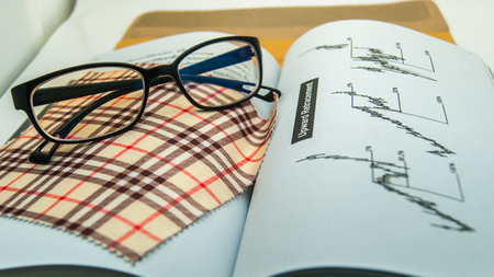 Eyeglasses with technician analysis, investment, financial, bookの写真素材