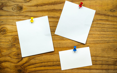 blank paper note on wood background with pinの写真素材