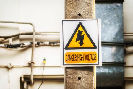 symbol danger high voltage at cement poleの写真素材