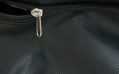 zipper on black bags texture backgroundの写真素材