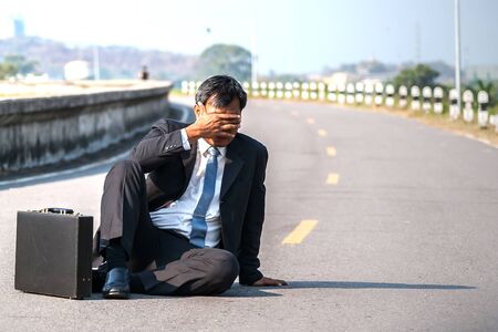 failed architect sits on the floor.The business man fail.