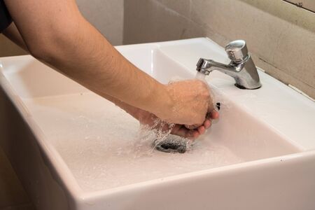 Washing hands in public toilet