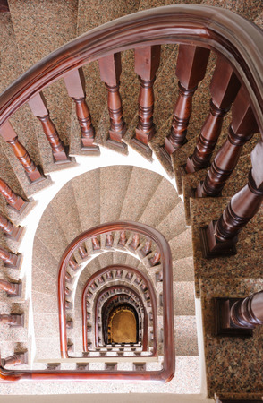 Vintage spiral staircase Interior in old house.の写真素材