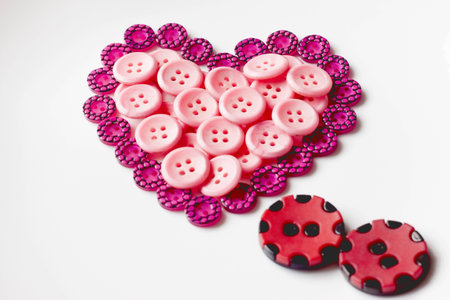 Two buttons look like a couple and a buttons which is in shape of heartの写真素材