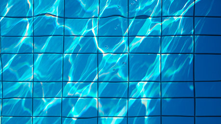 Close-up view of a swimming pool's tiled bottom with sunlight creating mesmerizing, shifting patterns of light and shadow on the clear blue water's surface.の素材