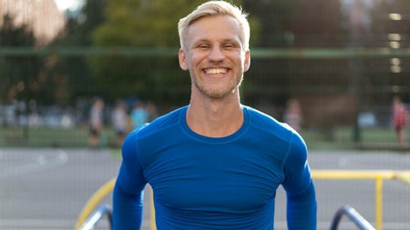 a guy with a beautiful smile is training on the playgroundの写真素材