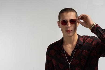 Close up portrait of handsome stylish man in round sunglassesの写真素材