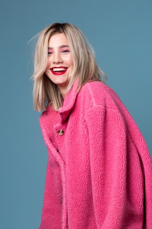 Young beautiful emotive girl smiling looking at cameraの写真素材