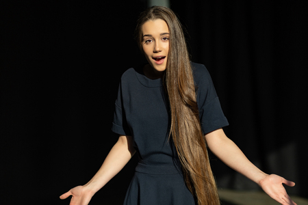 Young unsure female model with long straight hair