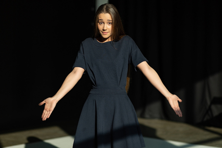 Glamorous young female model in black dressの写真素材