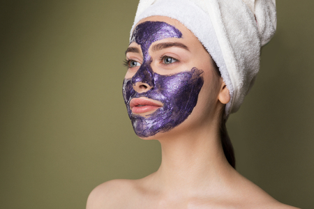 Close up portrait of young woman with towel on her headの写真素材
