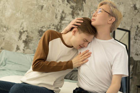 International gay male partners reconcile after quarrelの写真素材