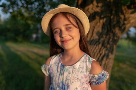 Close up portrait of young beautiful girl with healthy natural skin wearing white hat smiling and...
