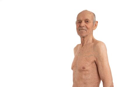 Waist up portrait of an attractive shirtless old man that smiling and looking at the camera isolated over white backgroundの写真素材