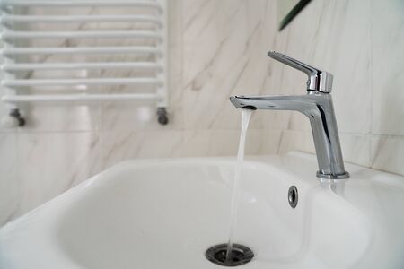 Water flowing from the faucet with sink. The water is not running. Water shortage. Save environment...